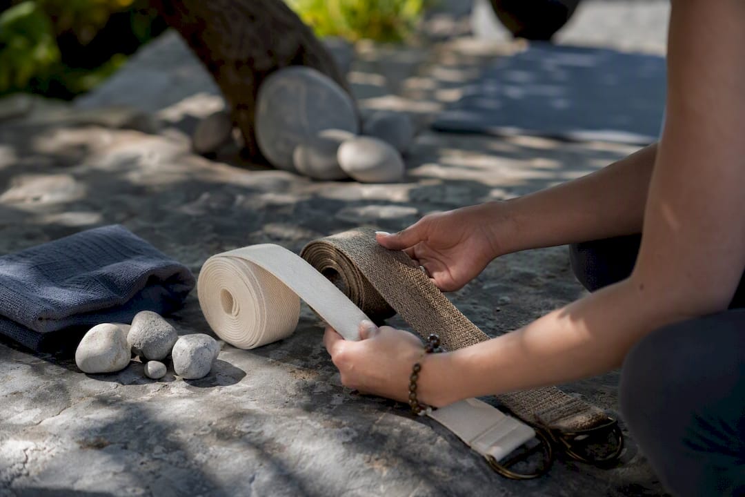 Hands holding eco-friendly yoga straps