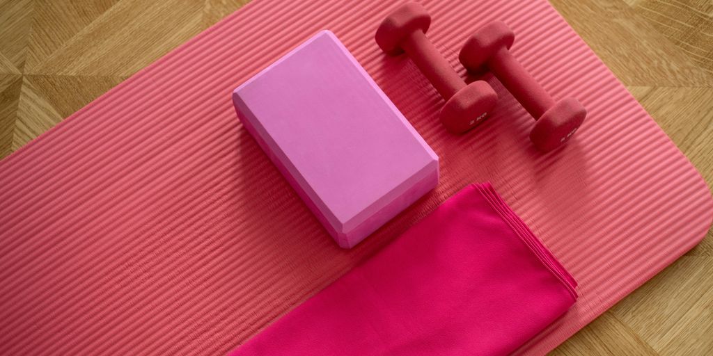 pink dumbbell on pink textile