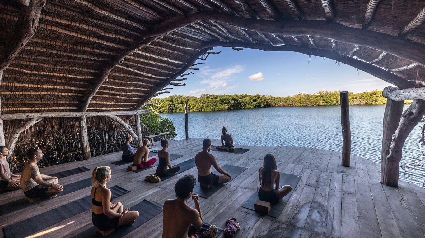 a group of people sitting on top of a wooden floor