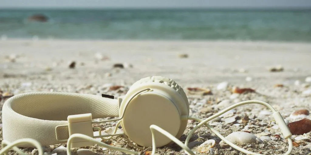 white plastic cup on white sand beach during daytime