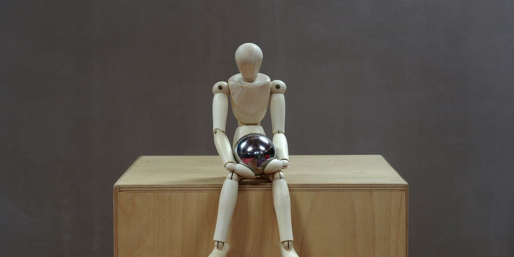 a white toy on a wooden shelf