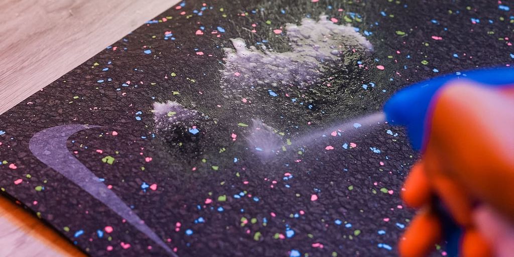 person washing yoga mat