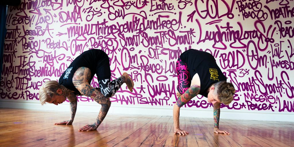 woman in black shirt and pink shorts doing yoga