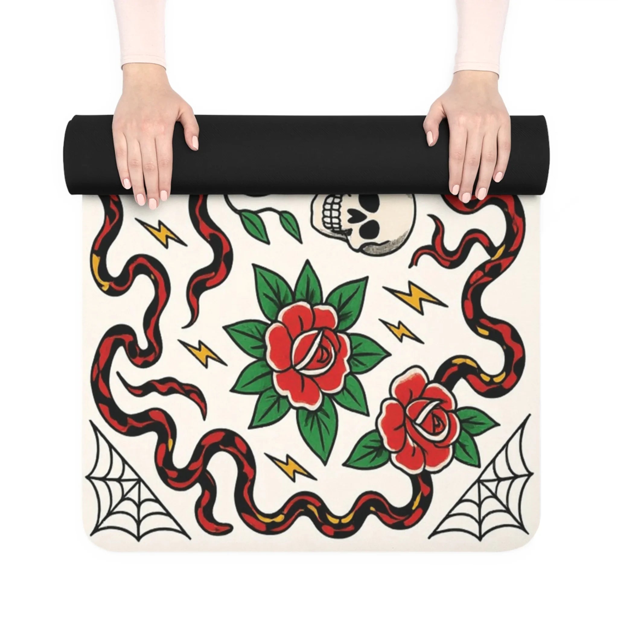 Yoga mat with snake, rose, and skull design held by a person