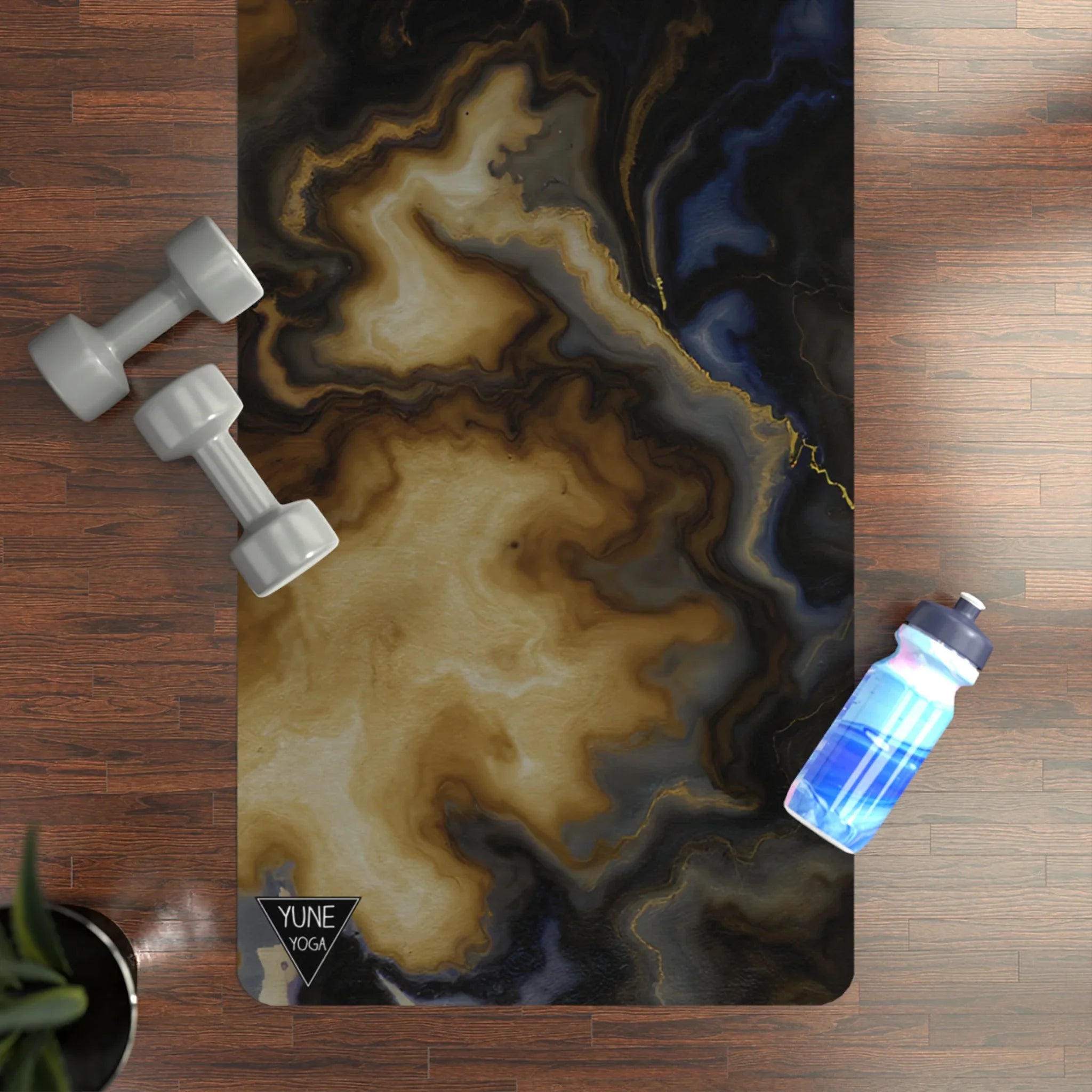 Marble pattern yoga mat on hardwood floor with dumbbells and water bottle, fitness setup