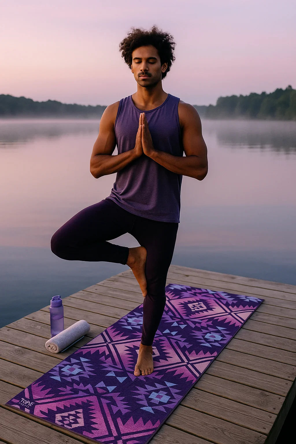 Man practicing yoga on a dock with a purple mat and water bottle.