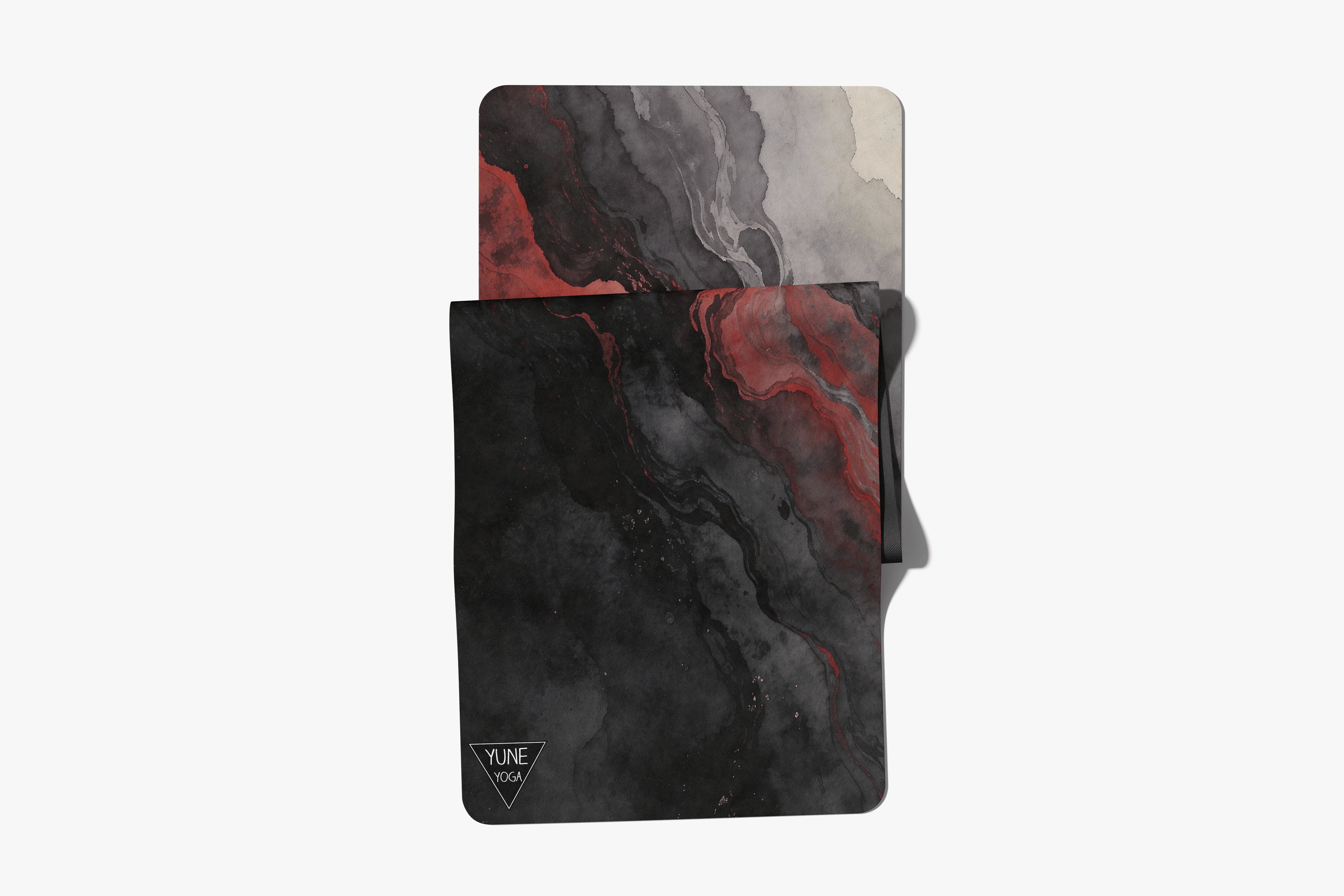 Black and red marble yoga mat and matching towel set with abstract pattern on white background