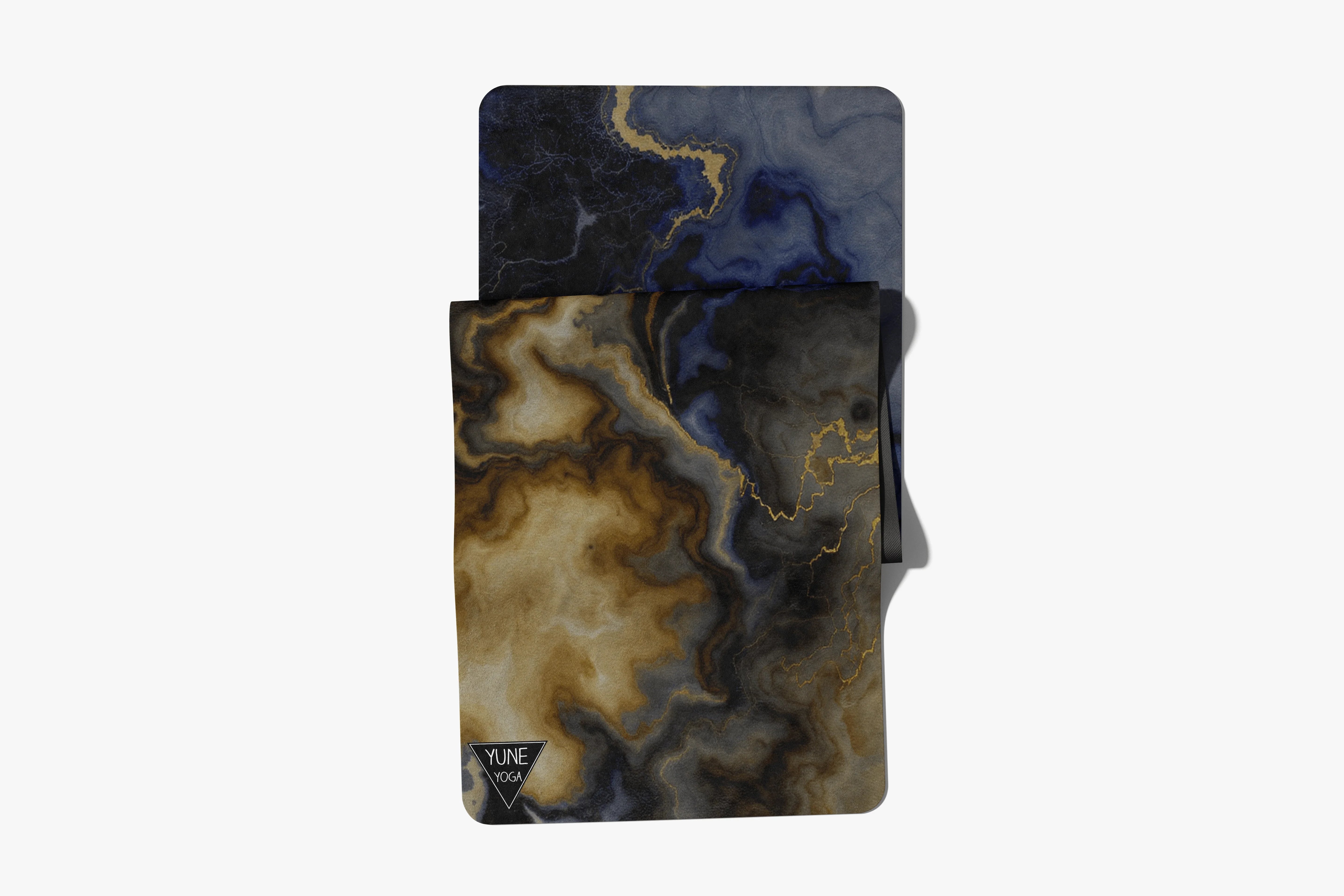 Marble-patterned yoga mat and towel set with black, gold, and blue abstract design
