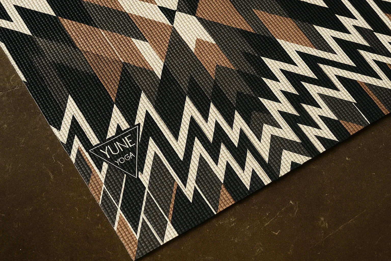 Yume Yoga mat with geometric pattern on a dark surface