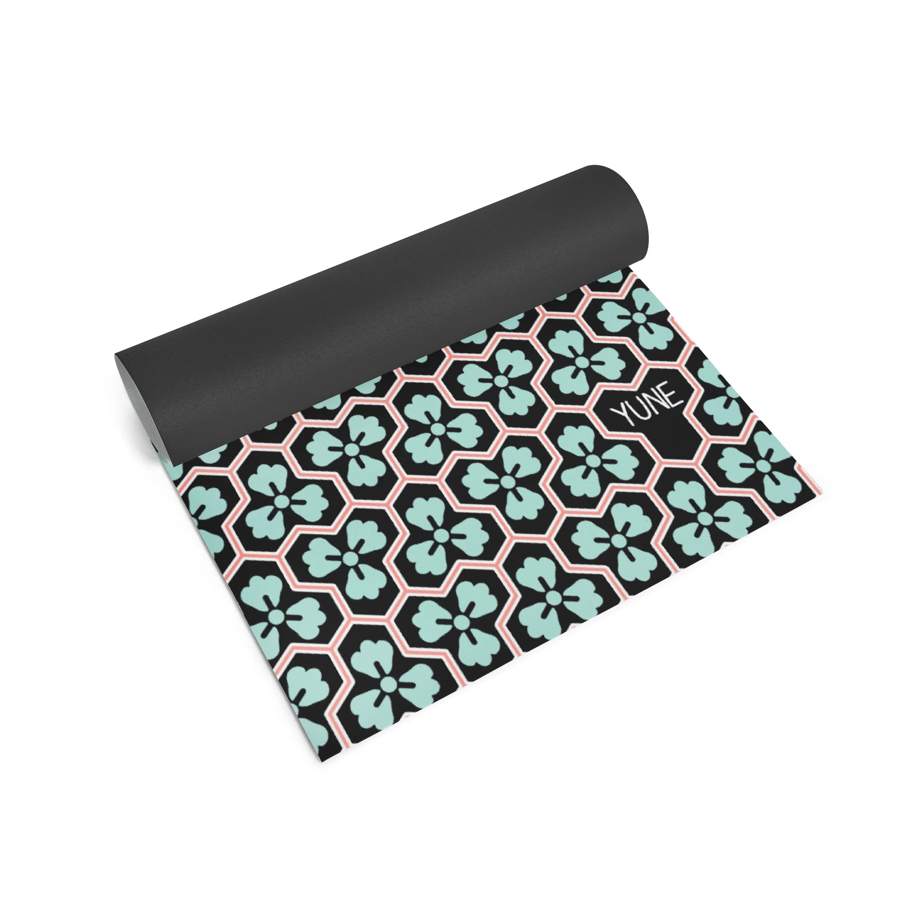 Yoga mat with geometric pattern and 'Yume' branding on a white background