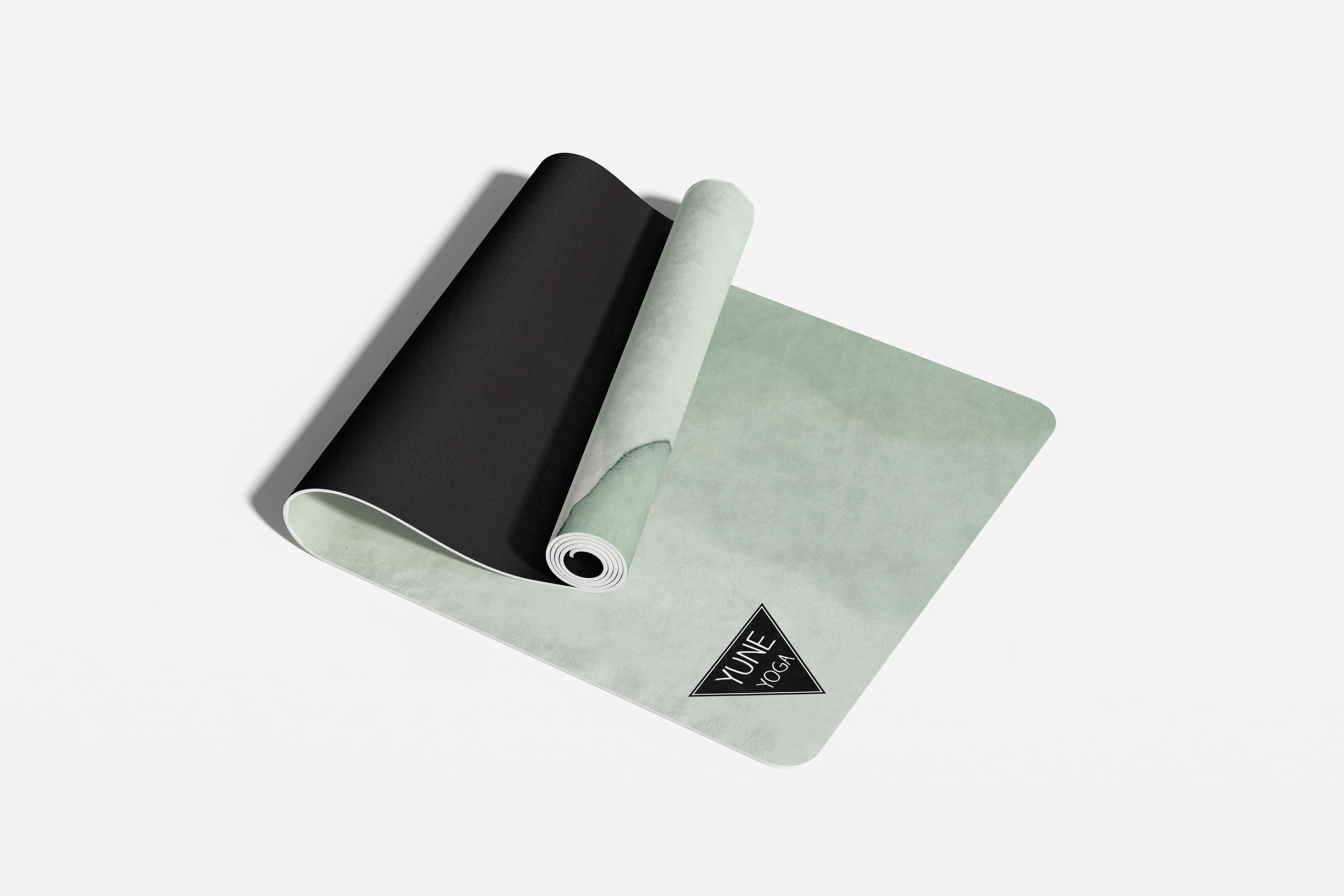 Two yoga mats, one black and one light gray, on a white background.