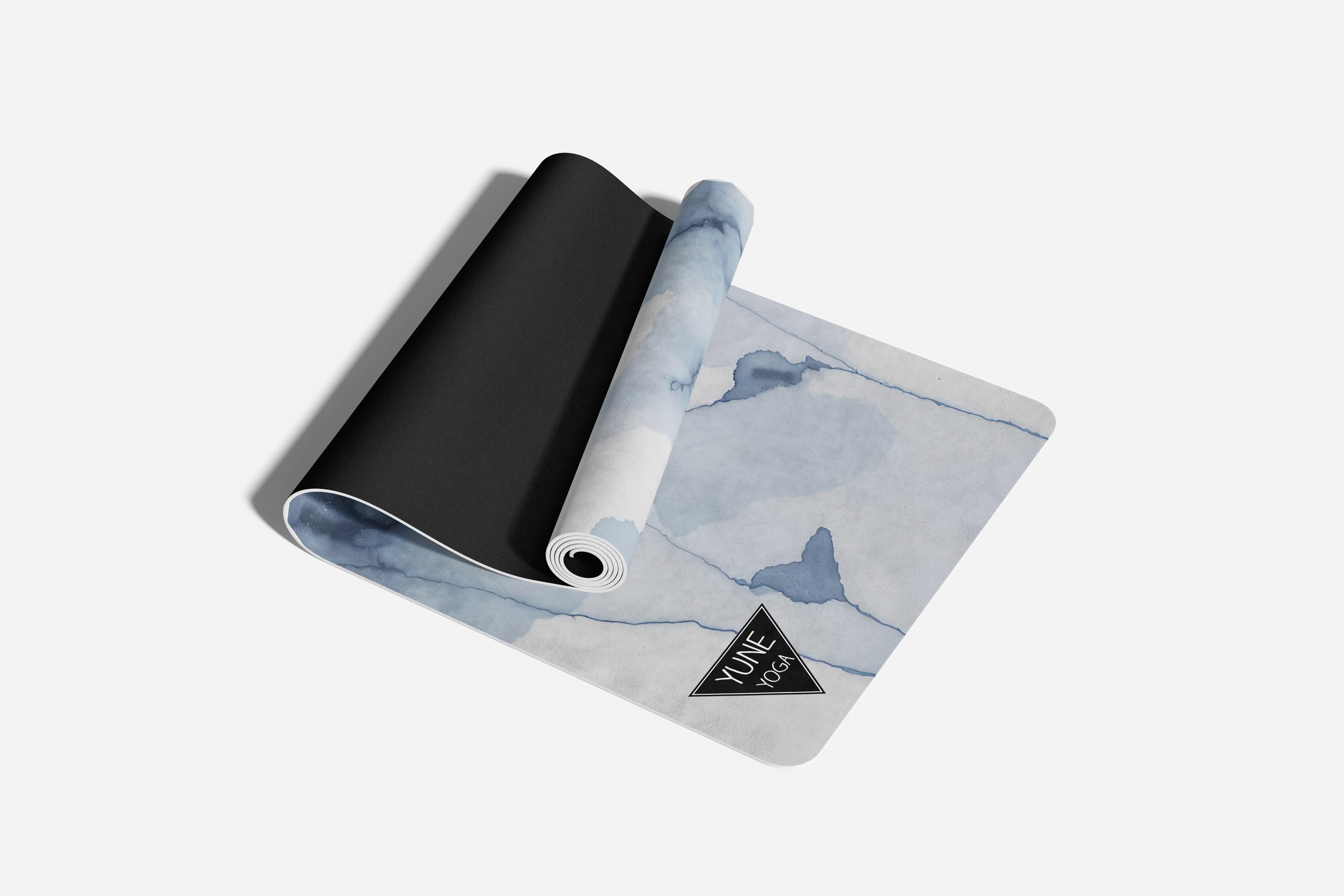 Yoga mat with whale design and brand logo on a white background