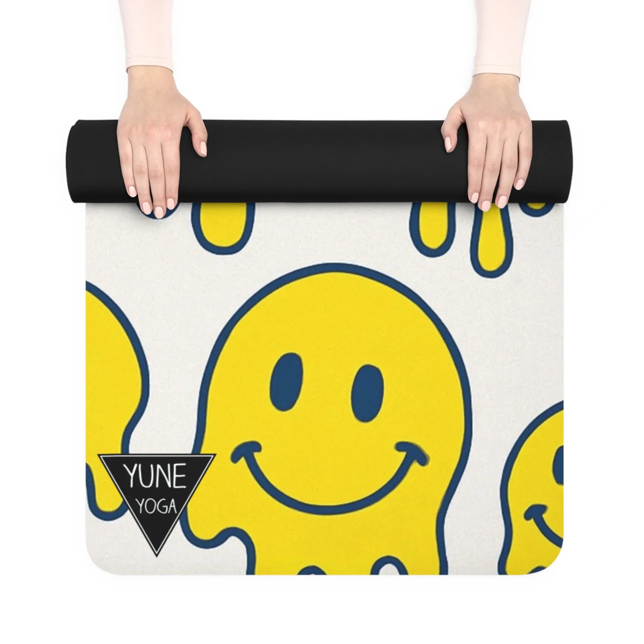 Yoga mat with smiley face design held by a person