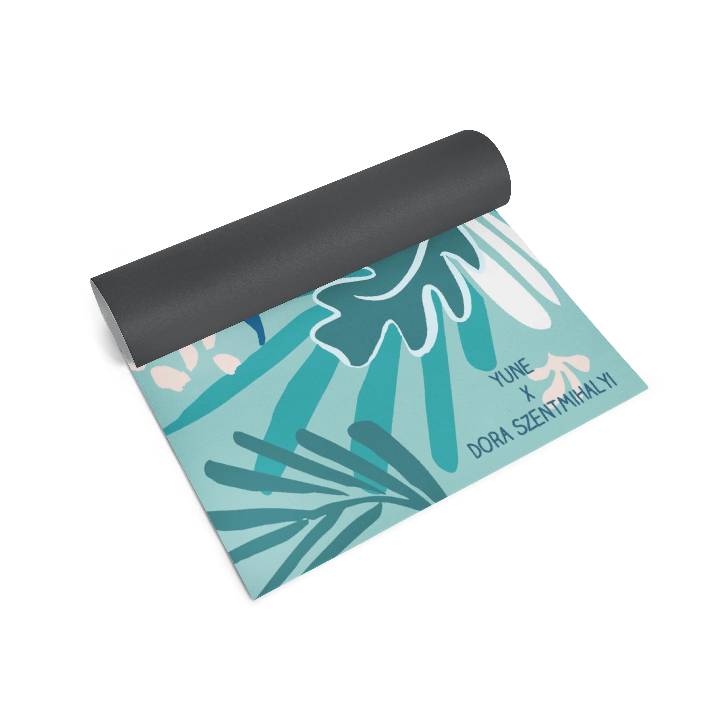 Yoga mat with tropical leaf design and visible branding on a white background