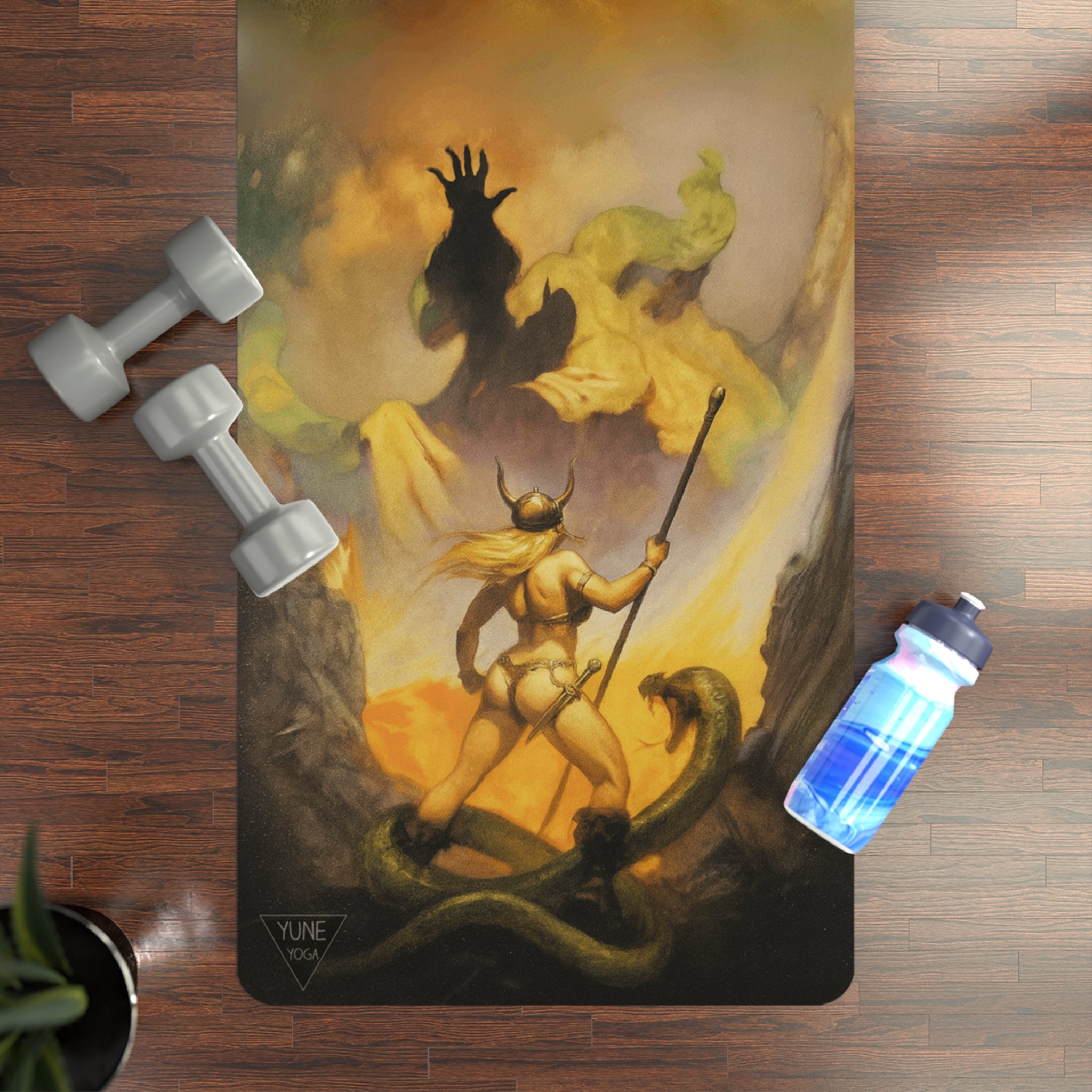 Yoga mat with a fantasy design featuring a warrior and serpent, placed on a wooden floor with dumbbells and a water bottle.