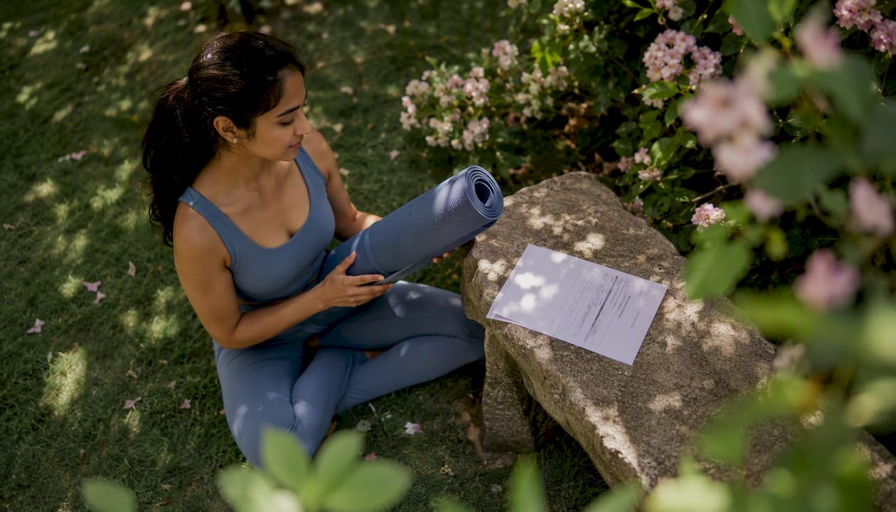 Woman inspecting certified yoga mat