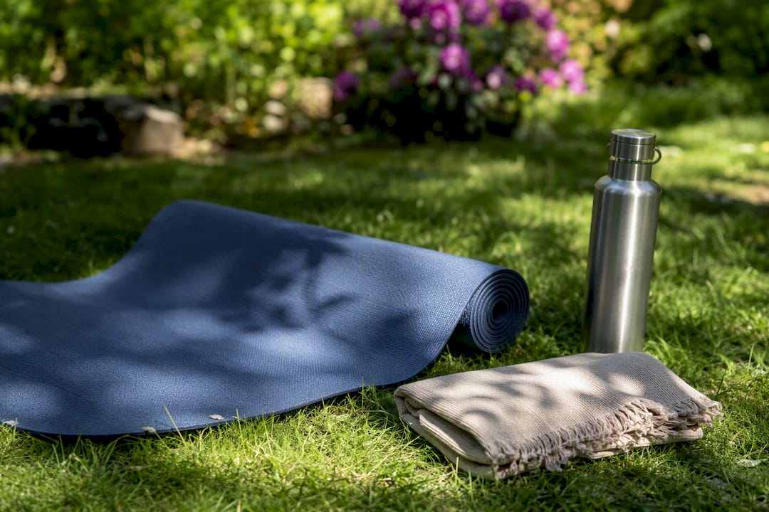 Partial eco-friendly yoga mat on wooden floor