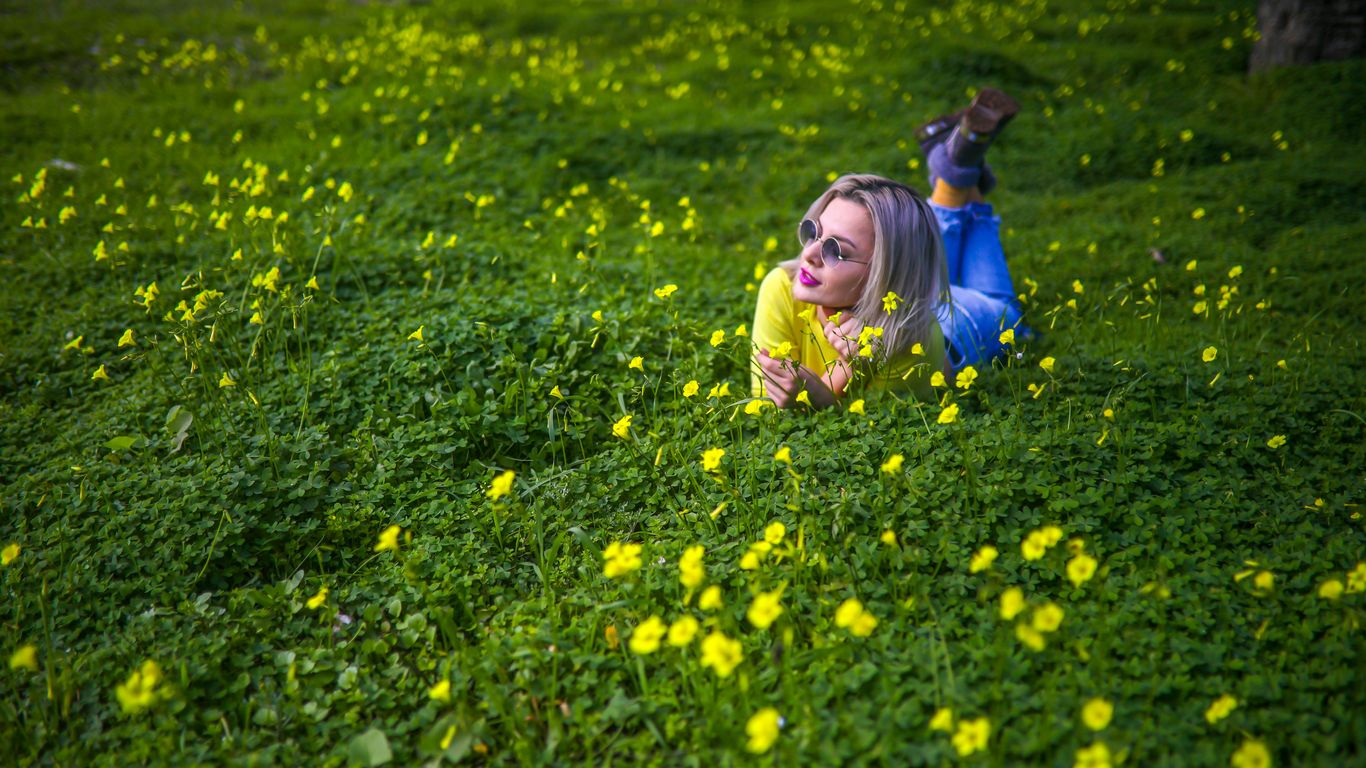 girl in yellow jacket on yellow flower field during daytime