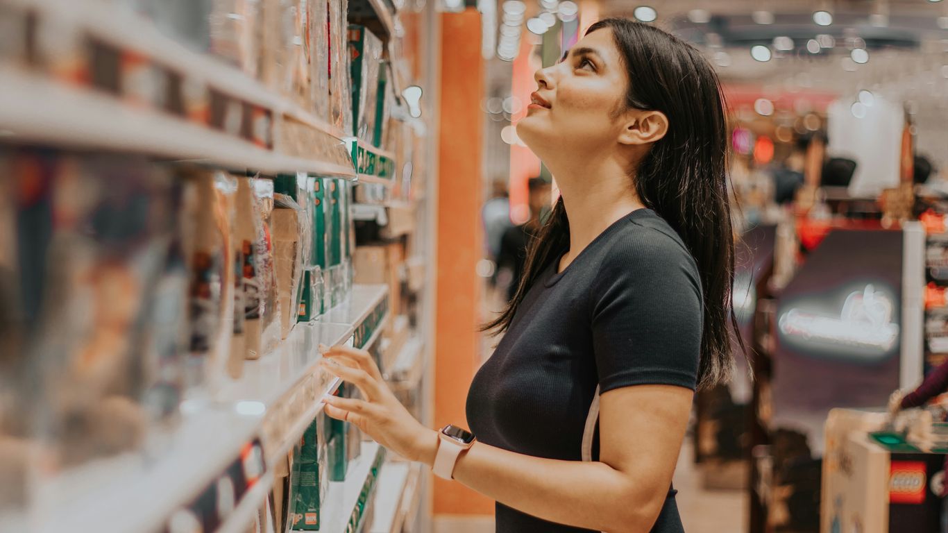 woman in black shirt standing near glass wall