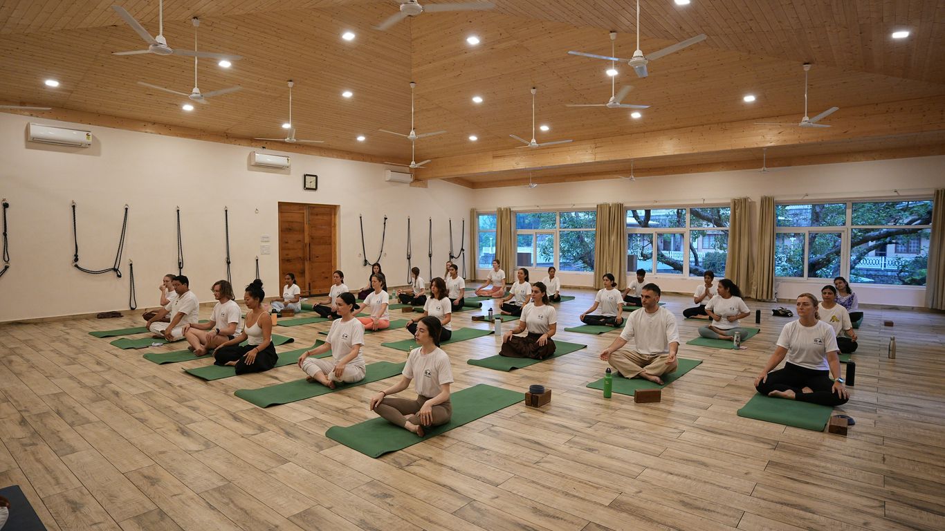 Group of people meditating in a yoga studio.