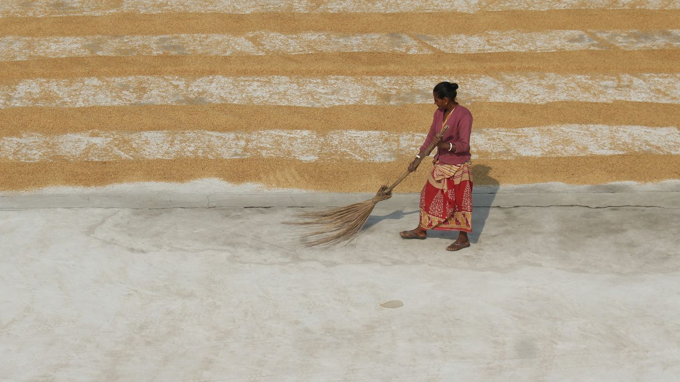 a man carrying a broom