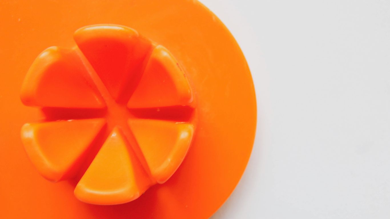 orange round plastic on white surface