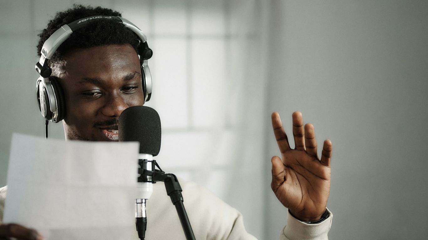 a man wearing headphones and holding a microphone