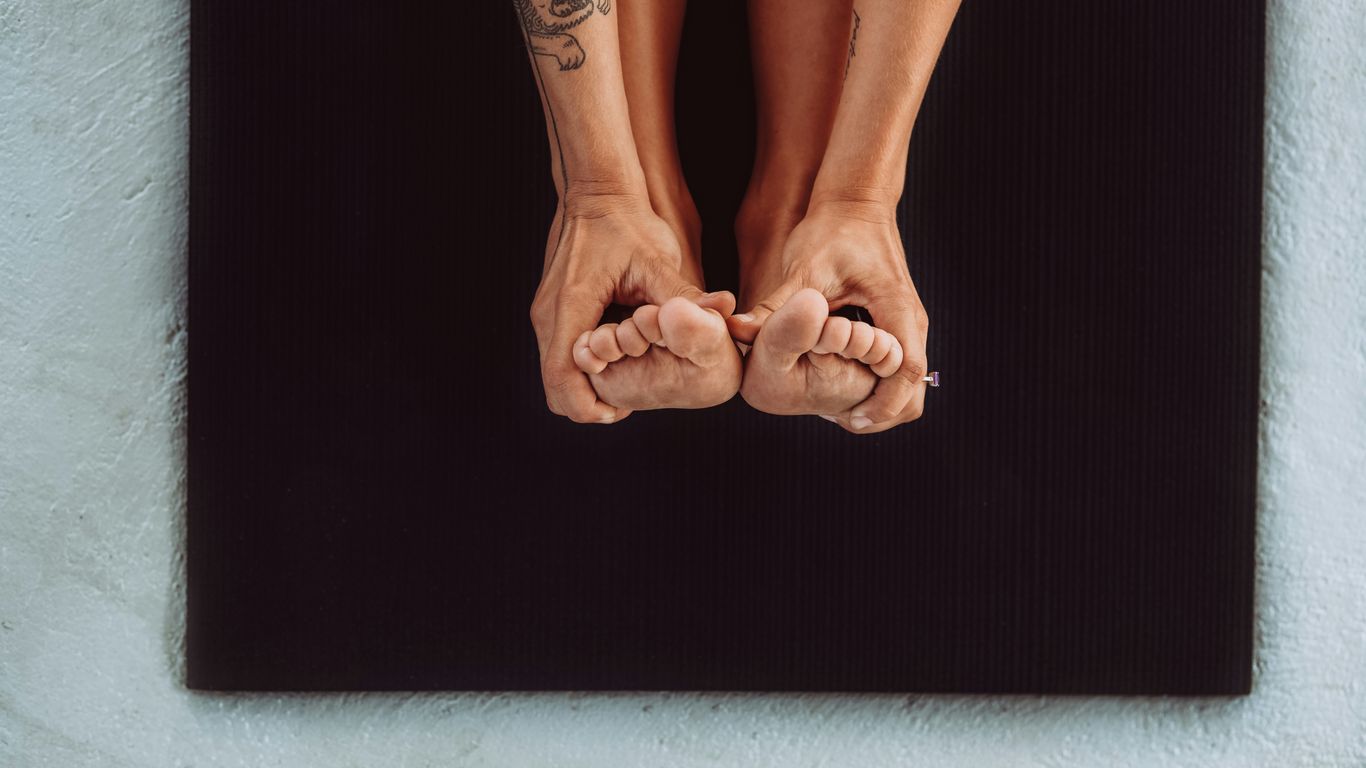 a woman's legs with tattoos on top of a mat