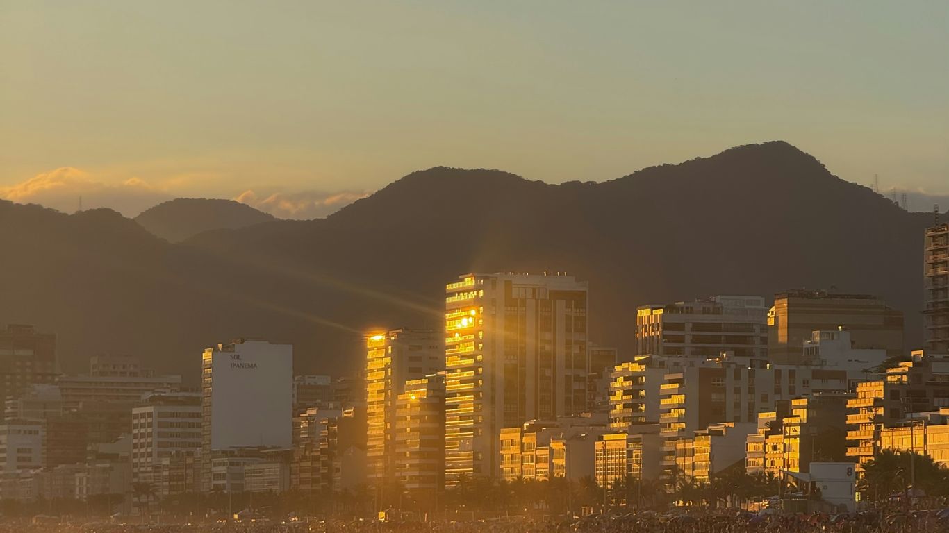 City skyline illuminated by golden sunset light.
