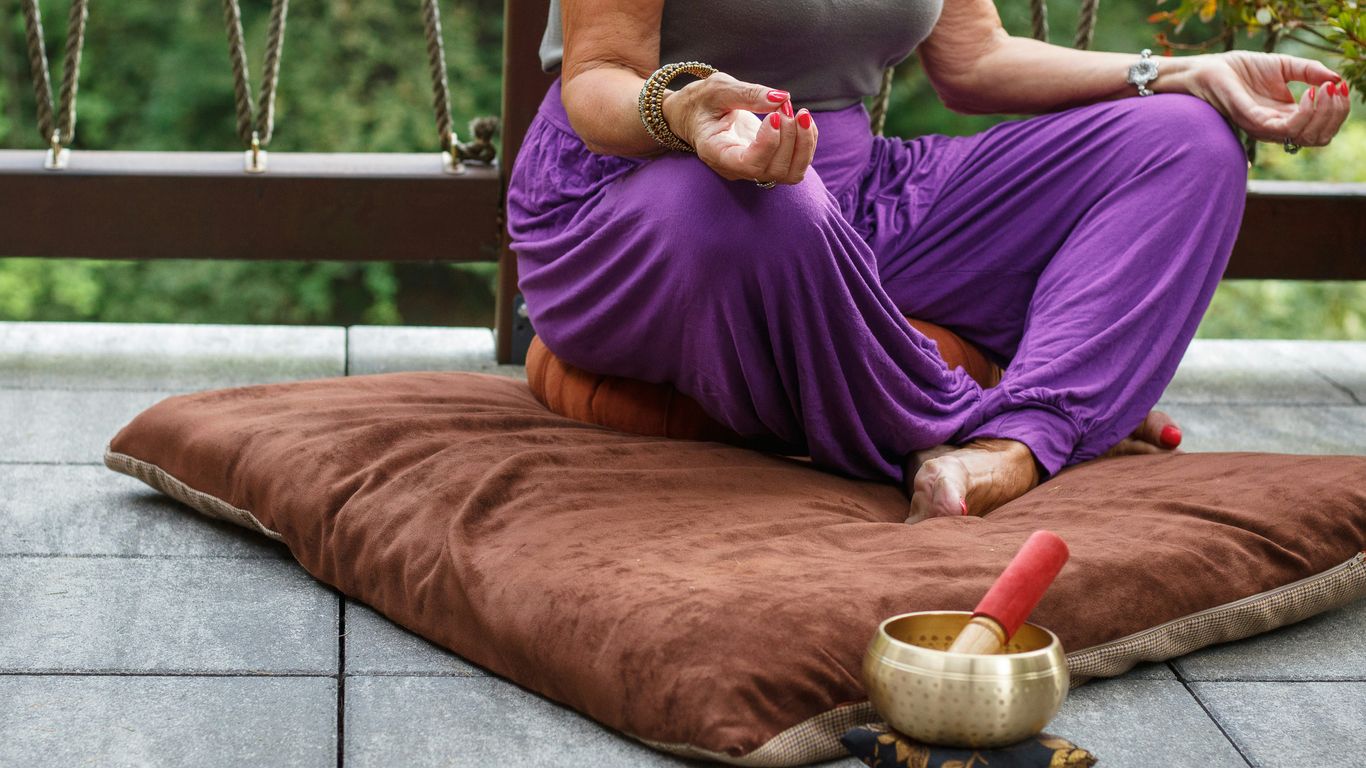 woman in purple dress sitting on gray couch