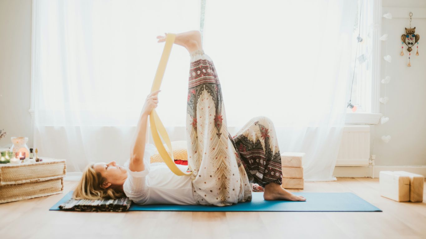 a woman doing a yoga pose on a yoga mat