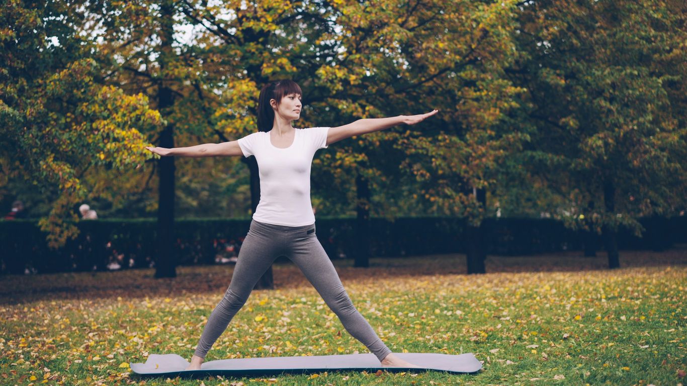 Woman practicing yoga in a park
