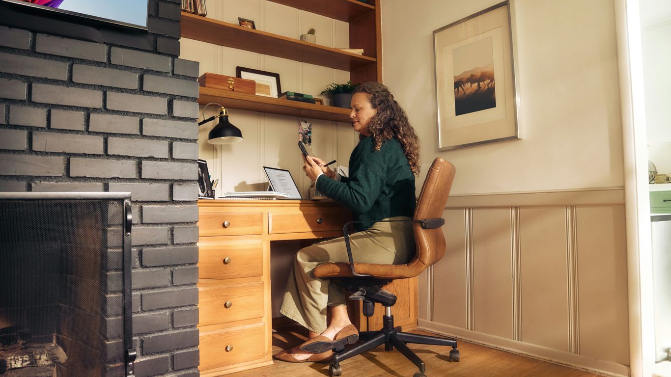 Woman working at a desk in a cozy home office.