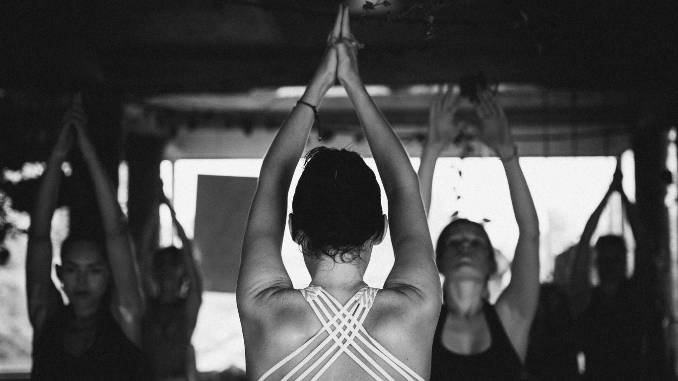 a group of women doing yoga in a room