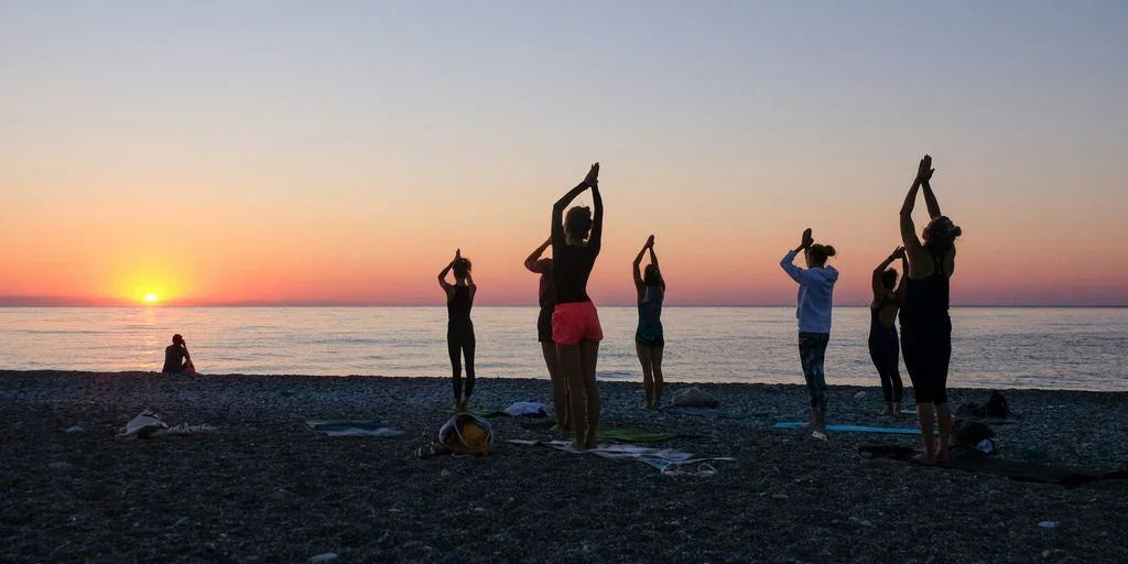 a group of people standing on top of a beach