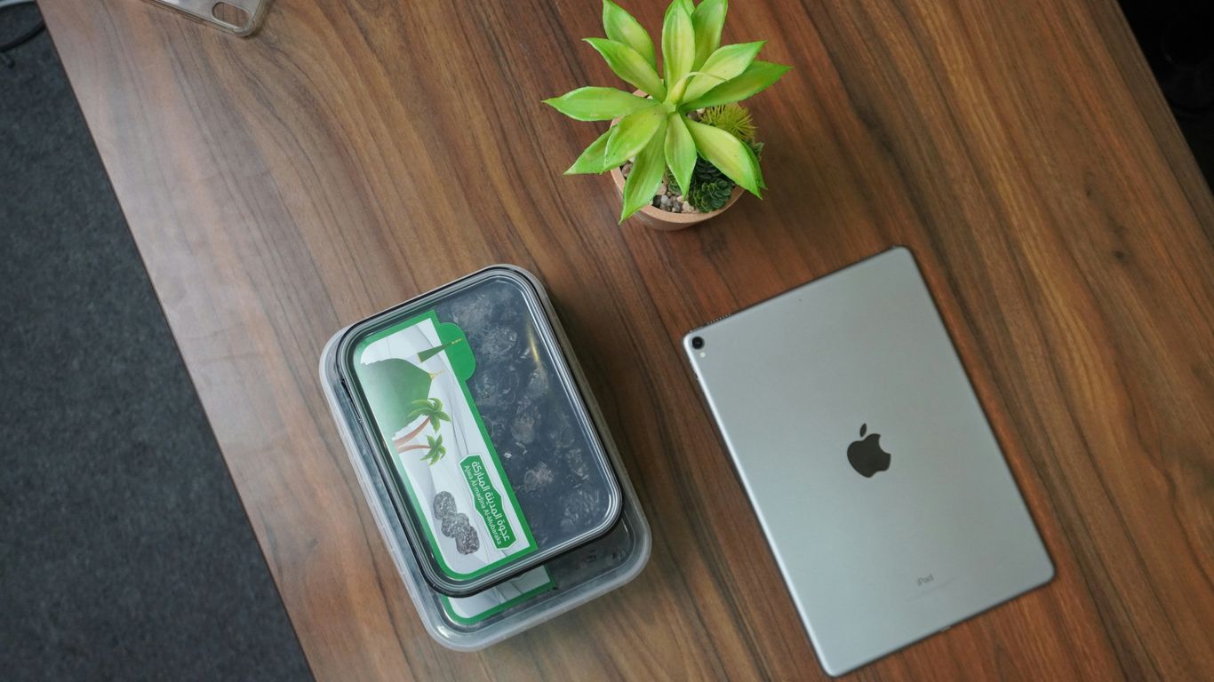 silver ipad on brown wooden table