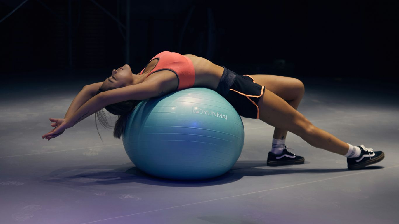 woman doing yoga on stability ball