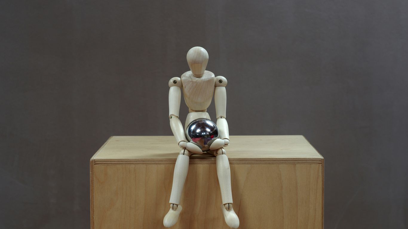 a white toy on a wooden shelf
