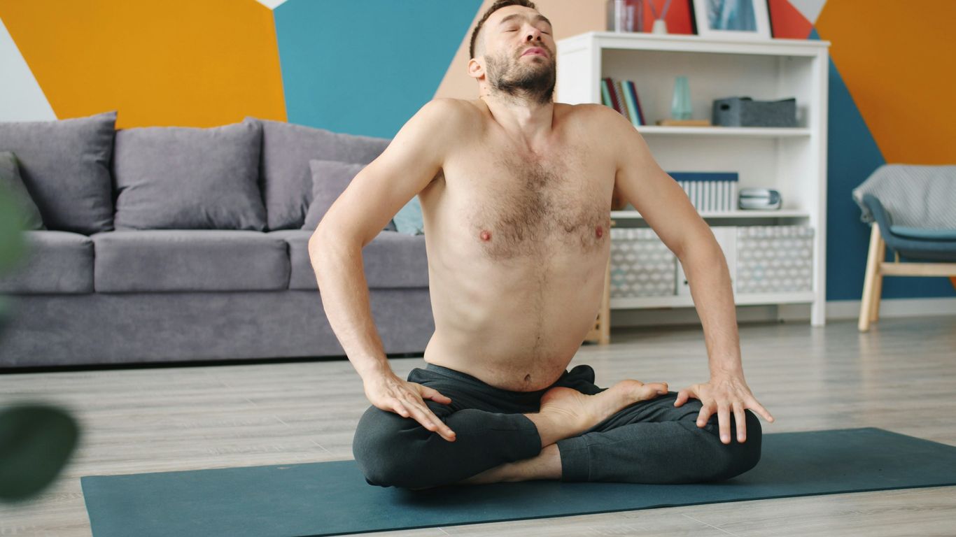 Man doing yoga in a living room
