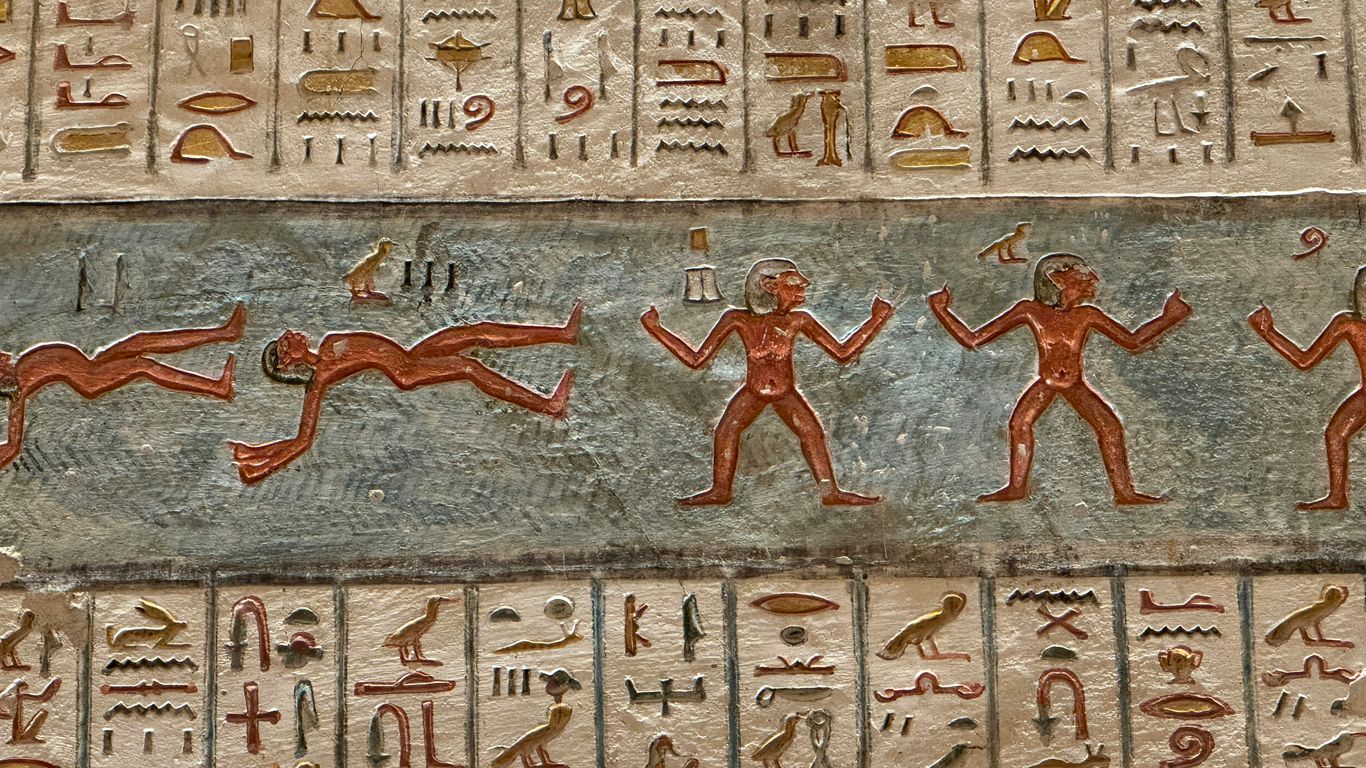 Ancient egyptian hieroglyphs and figures on wall paintings