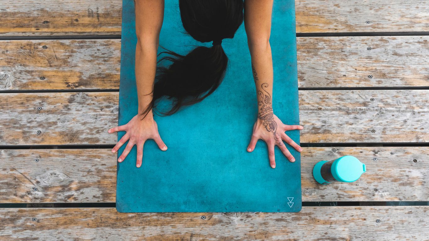 a woman is doing yoga on a mat