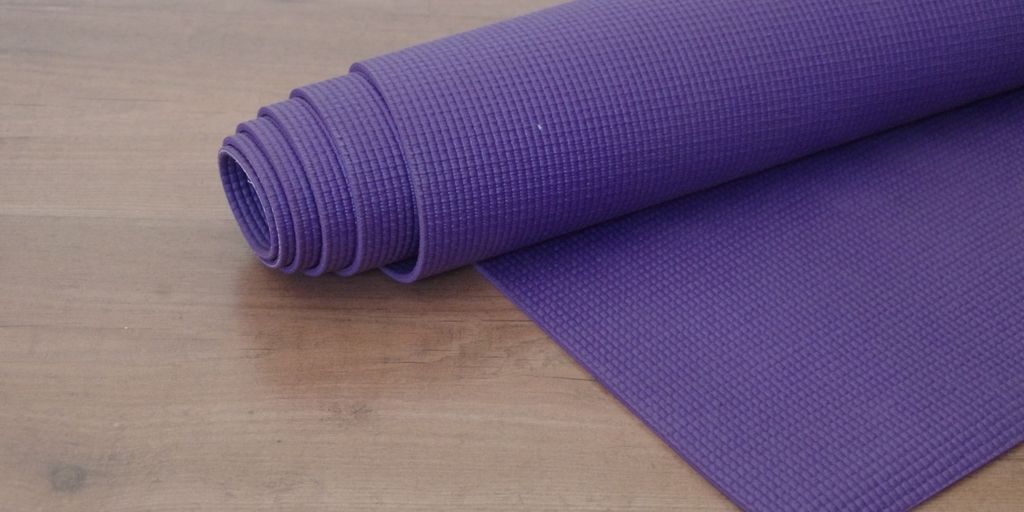 yoga mat spray in use in a peaceful yoga studio