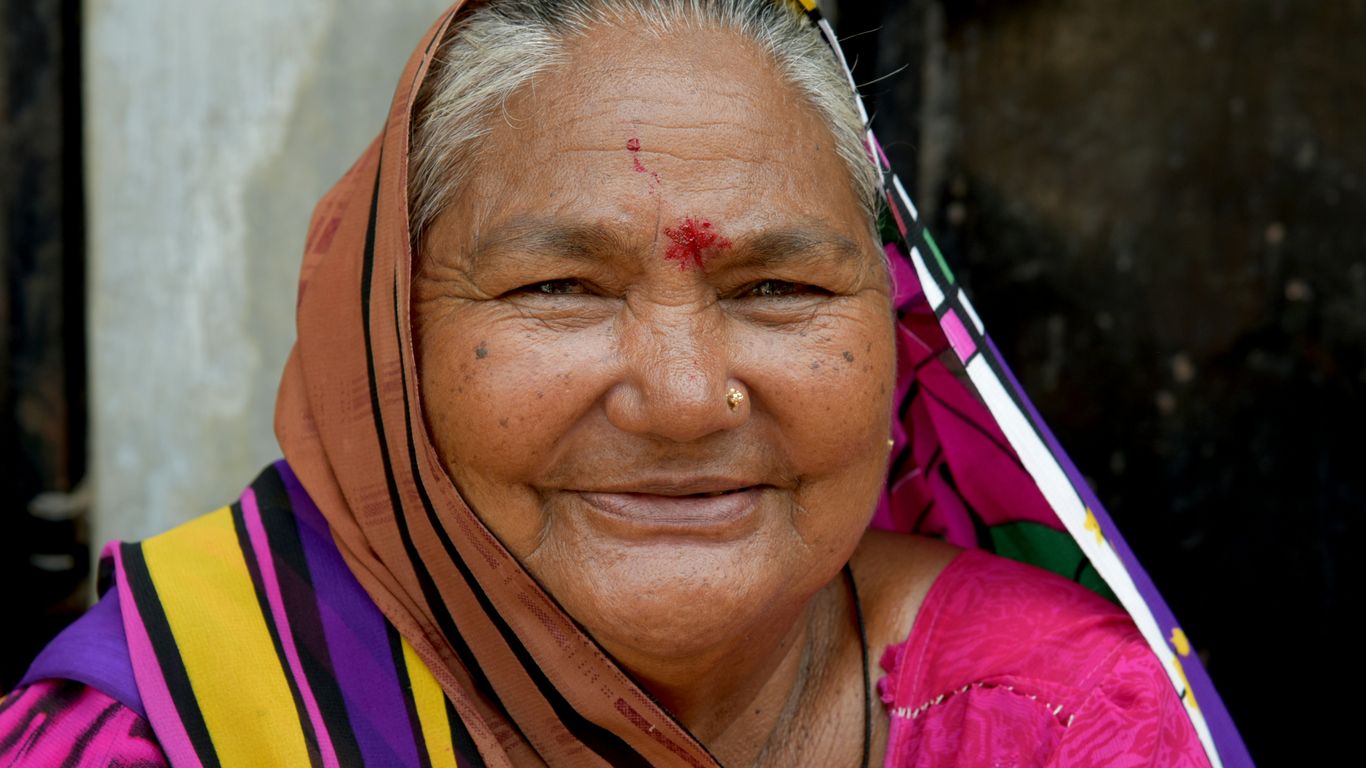 woman in pink yellow and blue sari