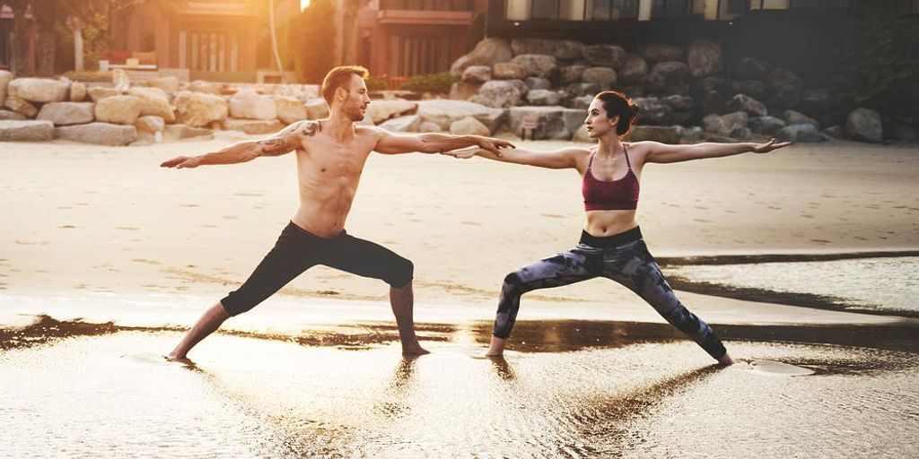 men practicing yoga on mats in a serene outdoor setting