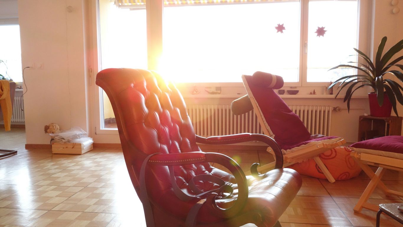 a living room filled with furniture and a large window