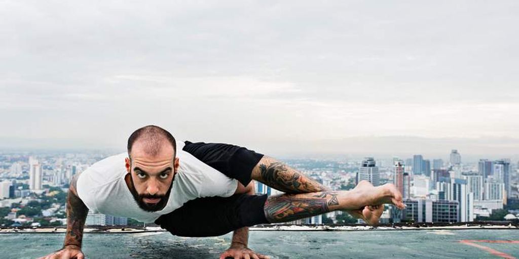 man practicing yoga in a peaceful outdoor setting