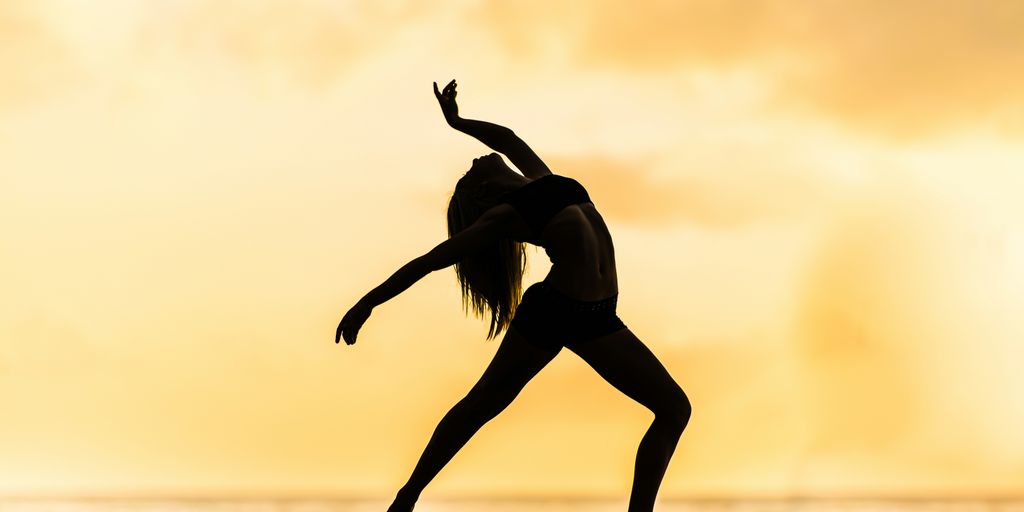 silhouette of woman making yoga pose