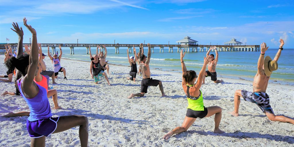 people exercising on seashore during daytime