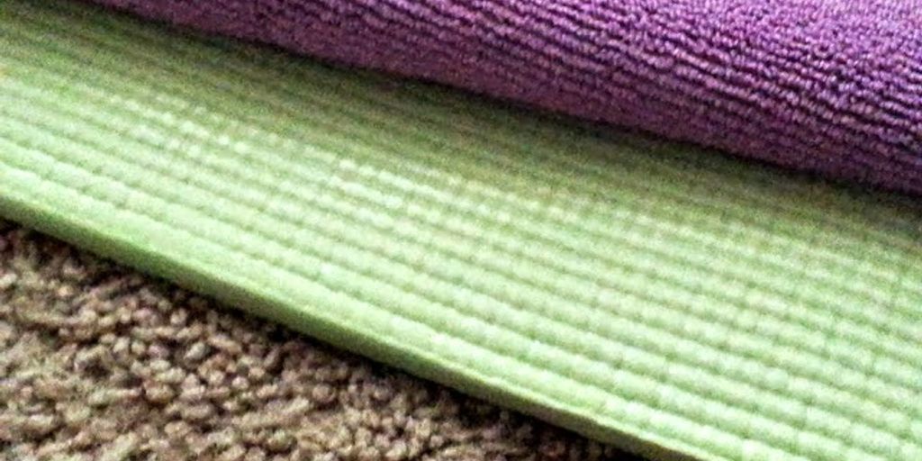 yoga mat on carpet in a cozy home setting