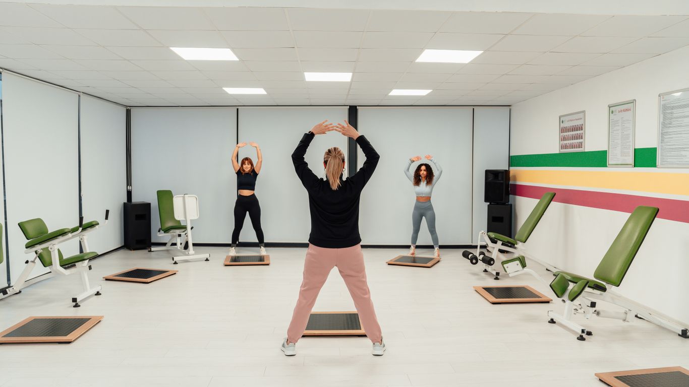 a group of people doing exercises in a room